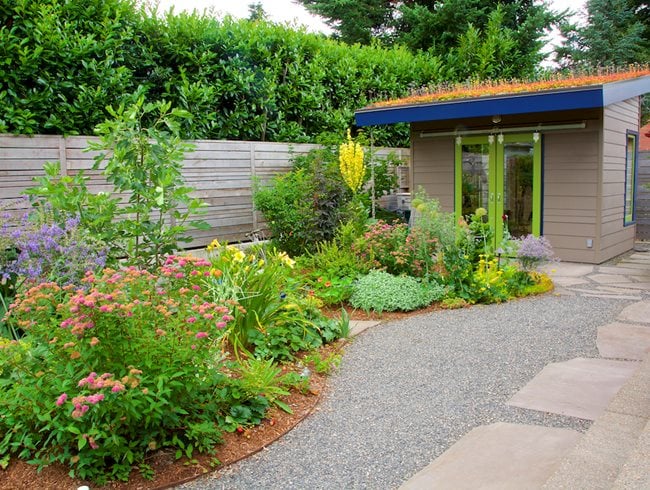 Small backyard with balanced hardscape, plantings and garden shed